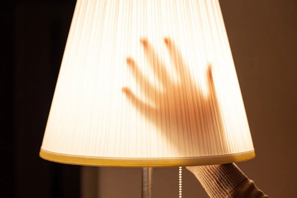 woman hand touch floor lamp