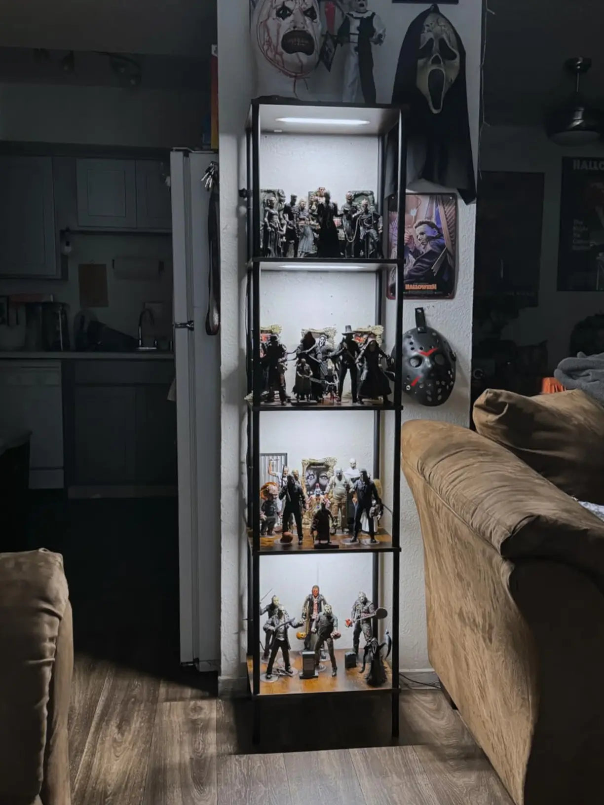 A sleek black metal display shelf equipped with adjustable spotlight lighting, showcasing various decor pieces and adding a sophisticated ambiance to any room.