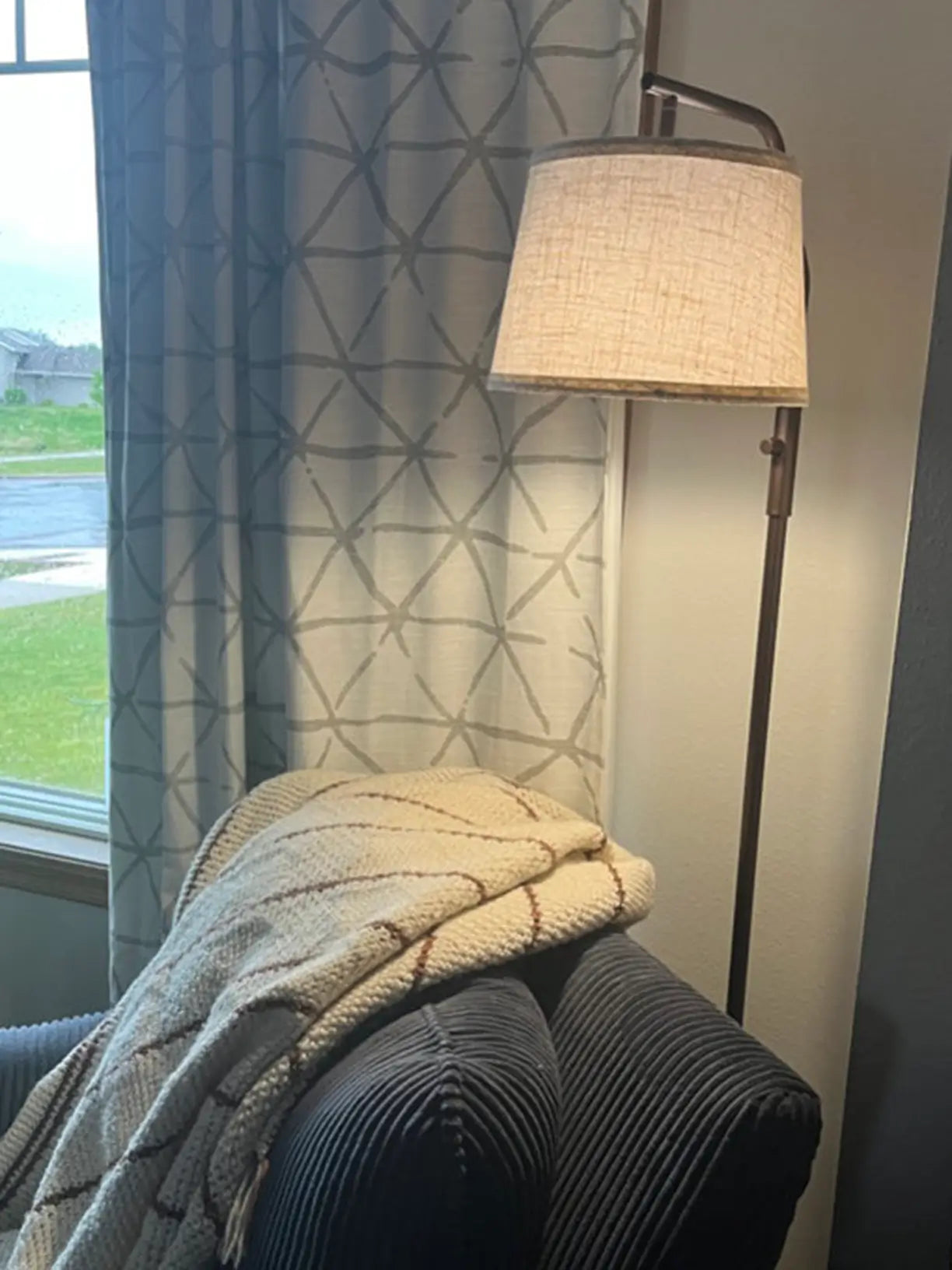 An industrial-chic arc floor lamp showcasing a visible bulb within a minimalist shade, offering a trendy lighting accent for a modern or eclectic interior.
