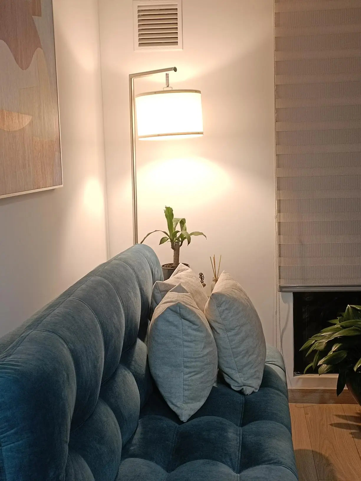 An industrial-style arc floor lamp featuring a metallic arm, fabric shade, perfect for adding a bold statement to a loft or spacious room.