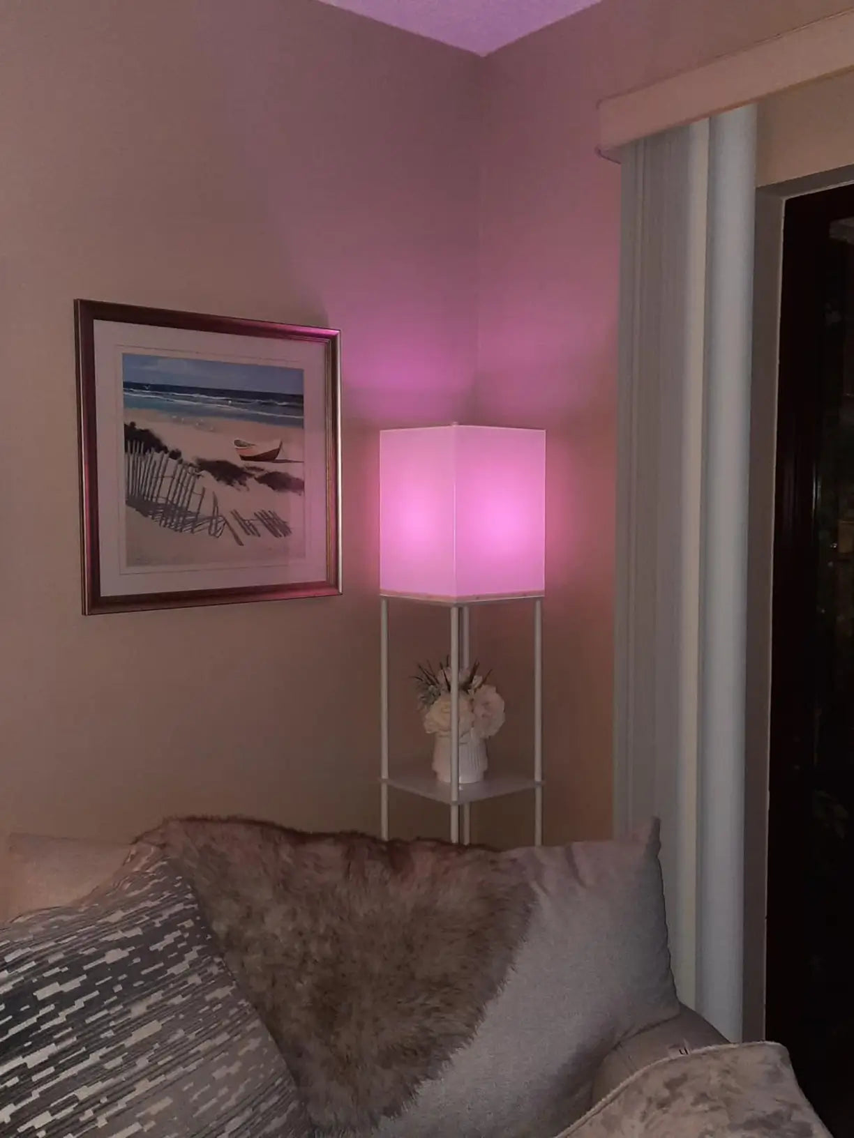 An LED RGB floor lamp creating dynamic and colorful lighting effects in a gaming room, fully adjustable via remote or smartphone app for an enhanced immersive gaming experience.