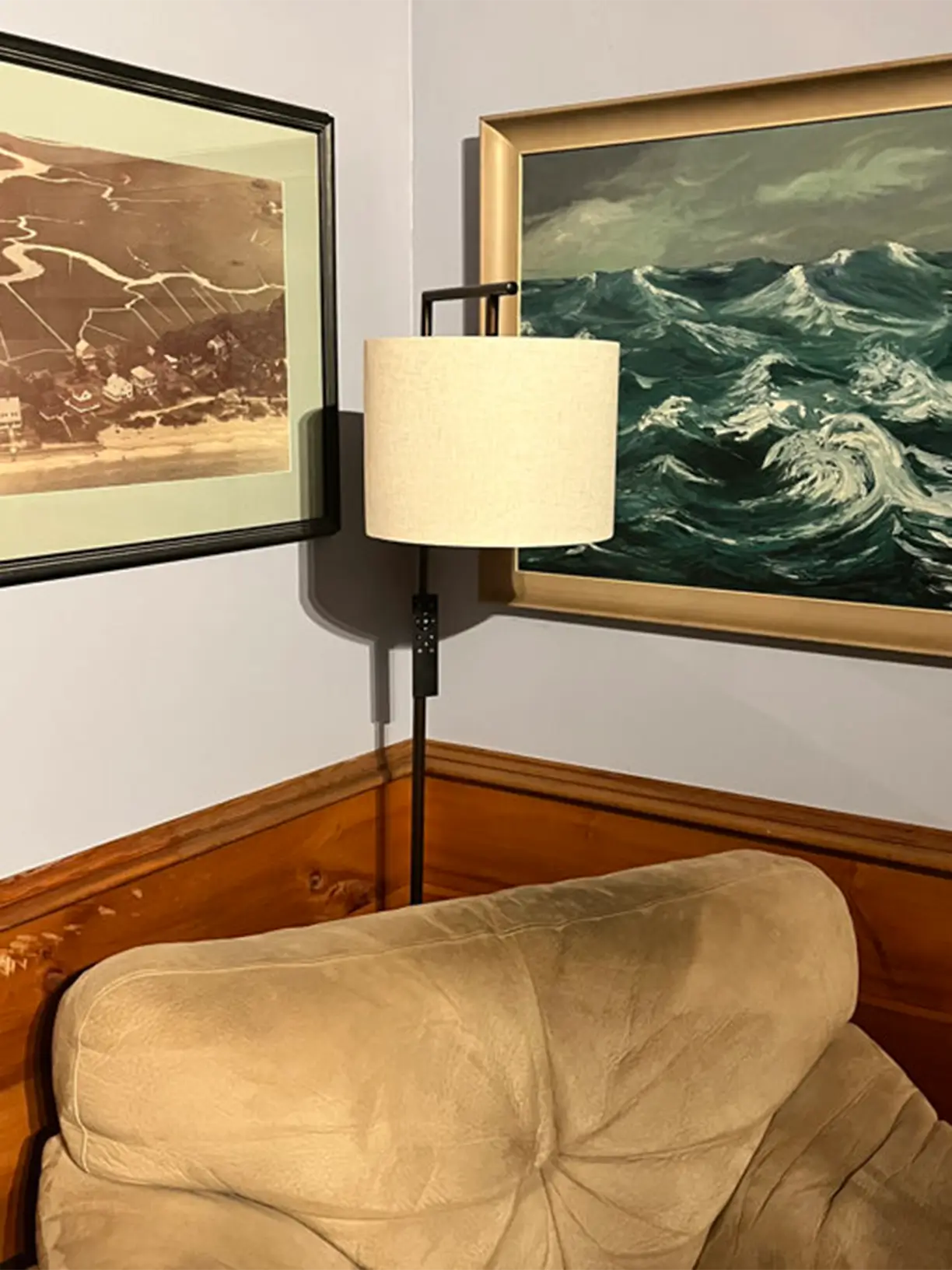A minimalist black arc floor lamp with a slender, curved arm and a simple dome shade, ideal for focused reading light over a sofa or armchair.
