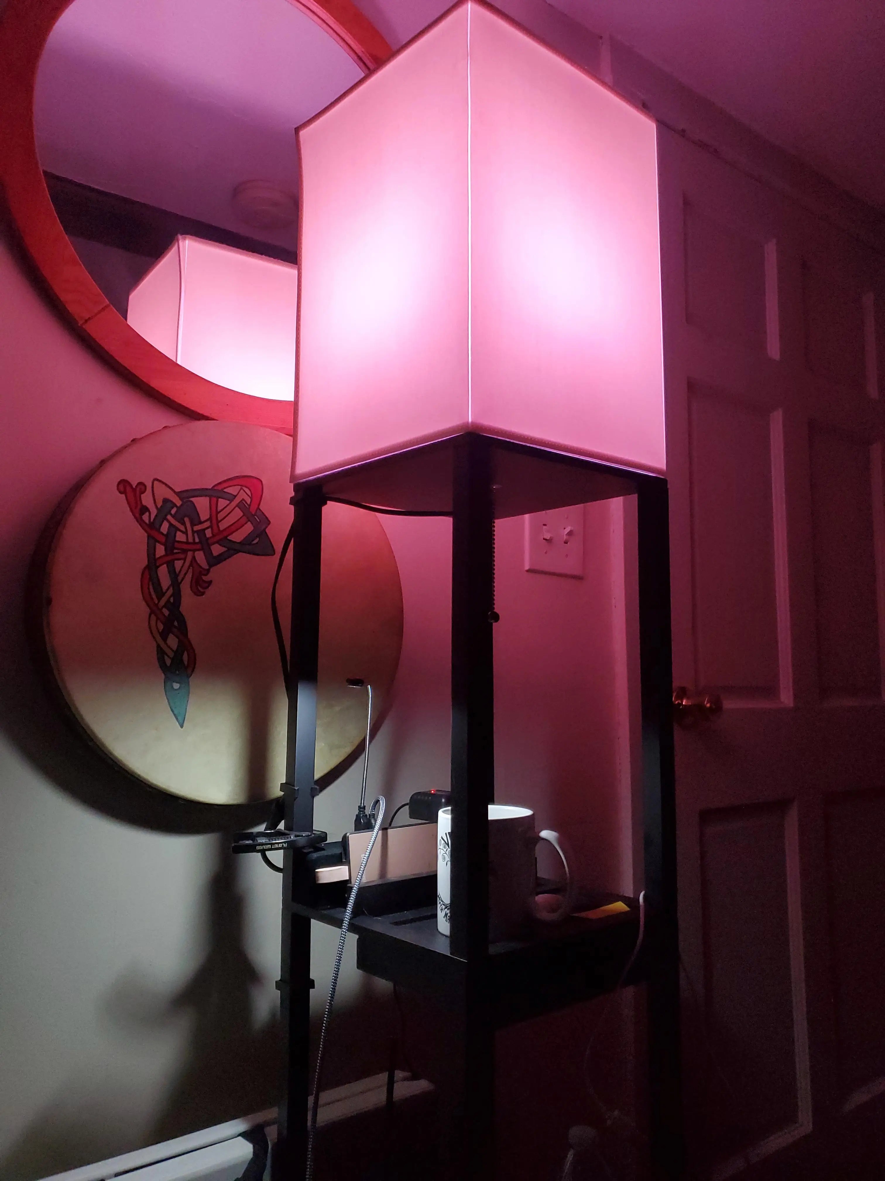 A minimalist RGB floor lamp designed for corner placement, producing a soft yet striking purple and blue light effect that enhances the architectural lines of a room.A minimalist RGB floor lamp designed for corner placement, producing a soft yet striking purple and blue light effect that enhances the architectural lines of a room.