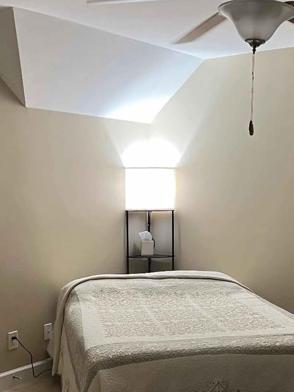 A modern corner shelf floor lamp with a dark wood-effect finish and integrated shelves, providing practical storage and warm illumination in a living room.