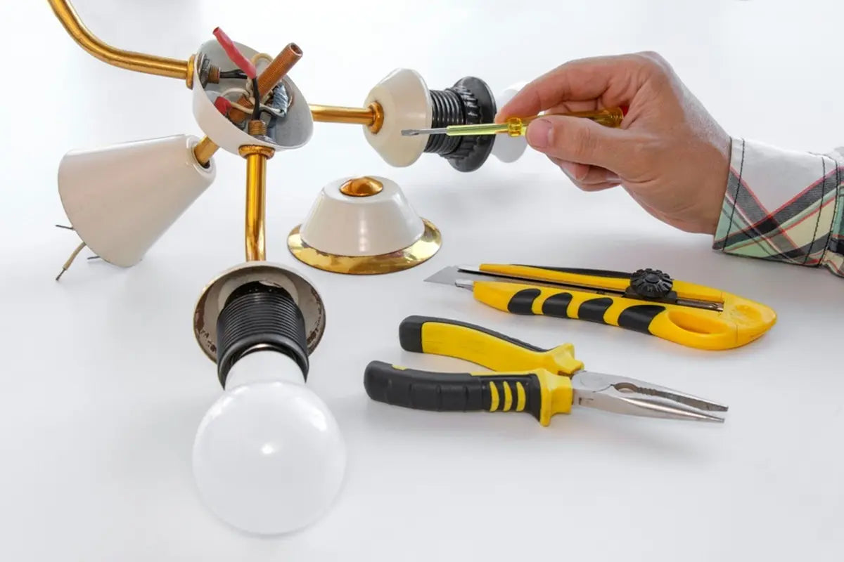 master repairs a disassembled electric lamp