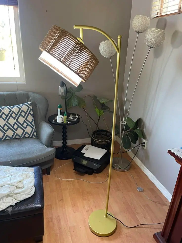 An adjustable double lampshade floor lamp with white conical shades positioned at different angles, providing directional lighting and a modern aesthetic suitable for various room layouts.