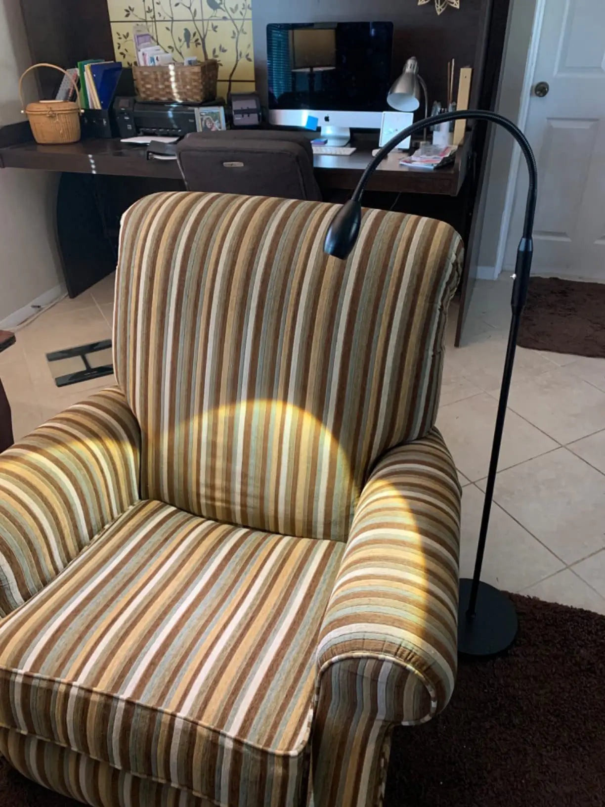 An industrial-style LED beam floor lamp featuring a sturdy black base and a powerful spotlight head, ideal for dramatic accent lighting or task illumination in a modern space.
