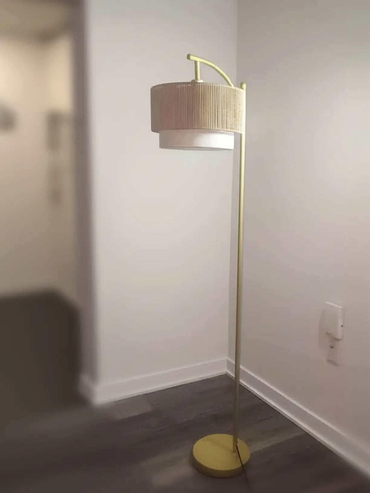 A modern double lampshade floor lamp with a sleek black base and two adjustable white fabric shades, providing versatile lighting for a contemporary living space.