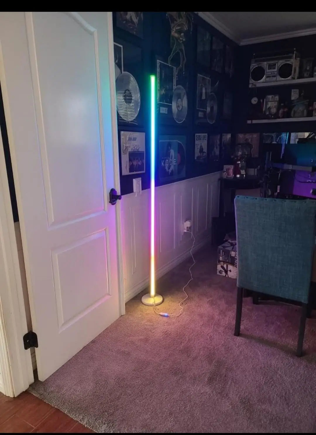 A modern RGB corner floor lamp emitting vibrant colorful light, creating an atmospheric ambiance in a contemporary room, ideal for gaming setups or accent lighting.