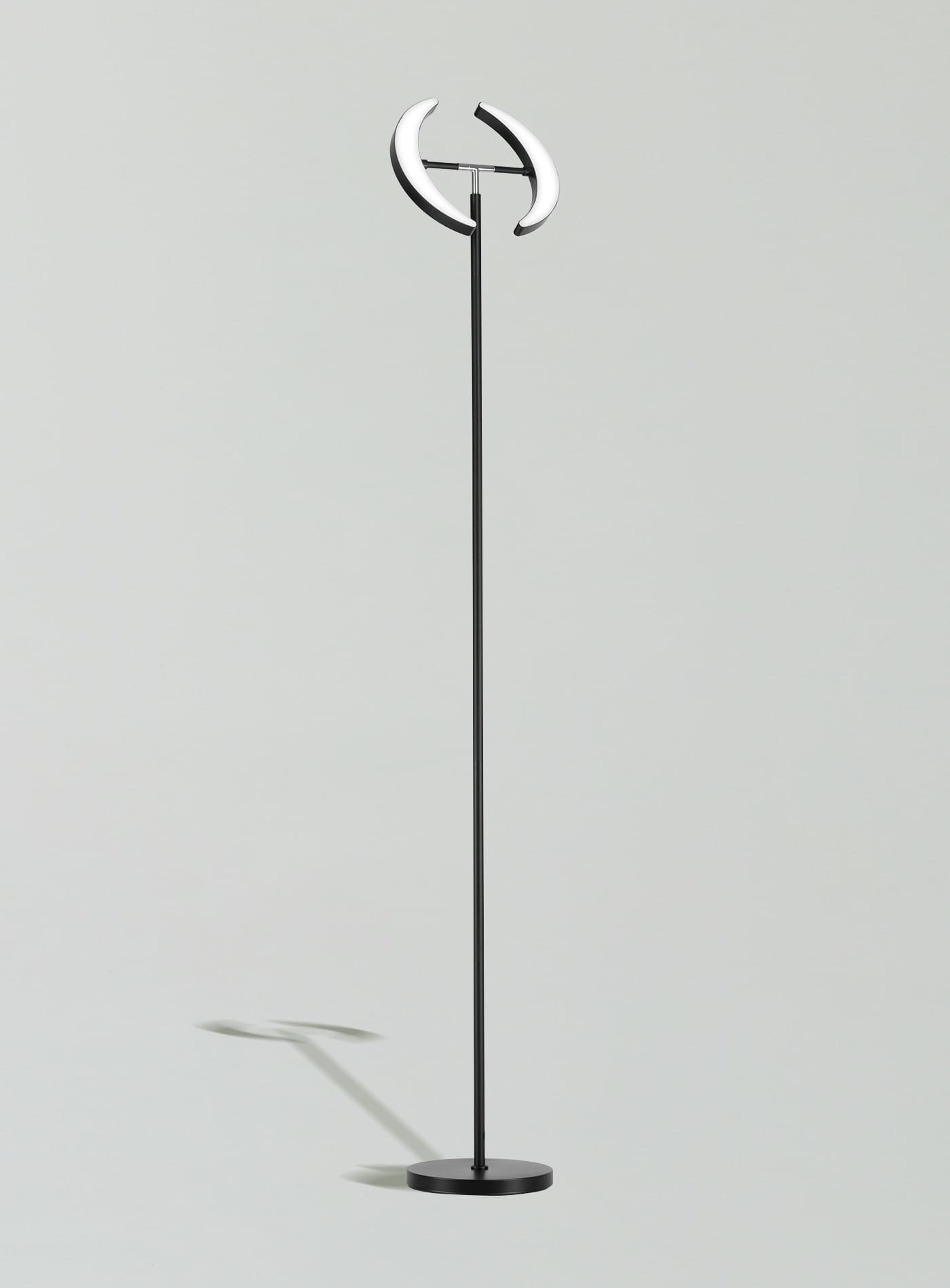 A sleek, black Sunmory Dual-Moon LED floor lamp with two rotatable heads, shown in a modern living room setting