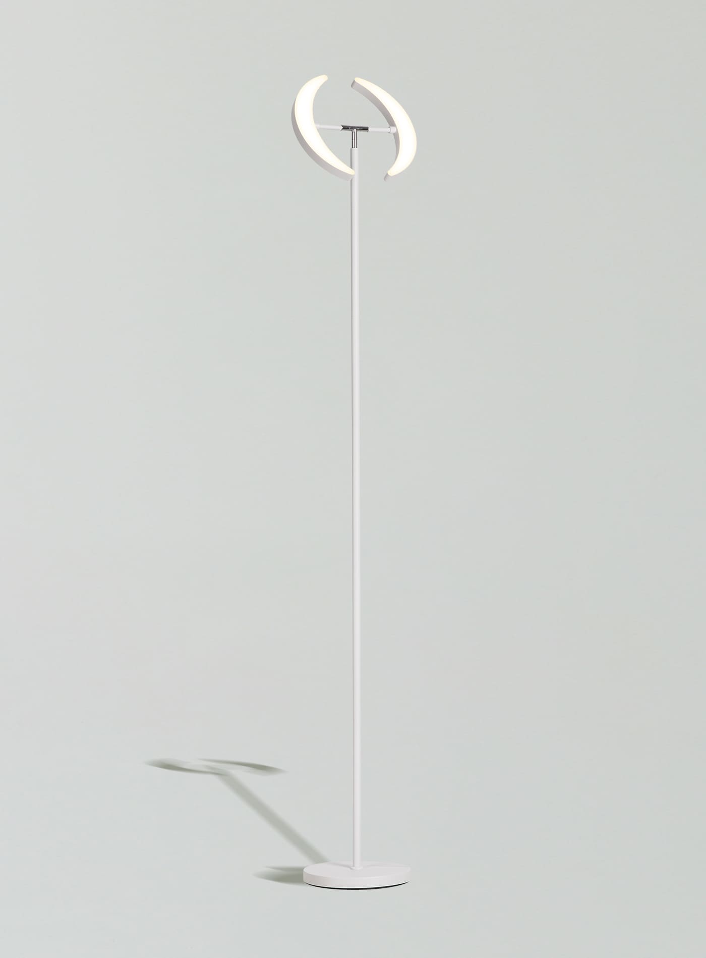 A modern, white Sunmory Dual-Moon LED floor lamp with remote control, perfect for brightening a bedroom corner
