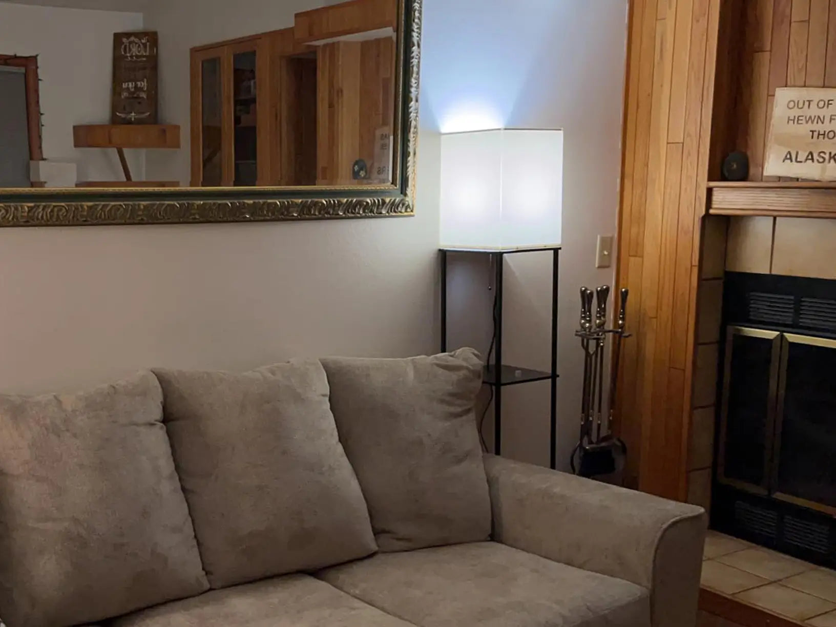 A stylish floor lamp constructed with a wooden-look frame and multiple open shelves. This versatile floor lamp is perfect for adding warmth and practical display space to any living area, ideal for showcasing small plants or books.